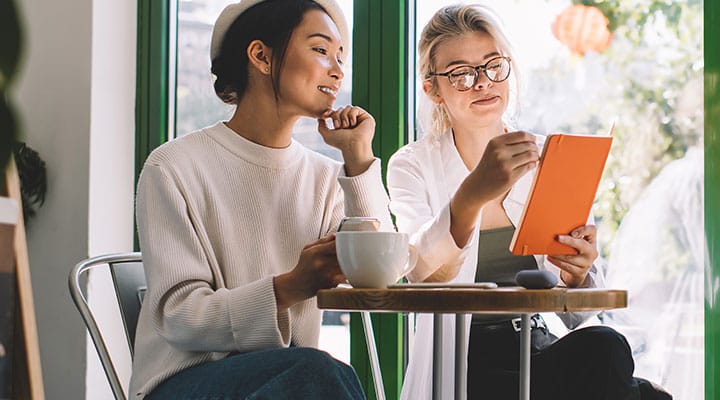 Two women looking on the tablet, 